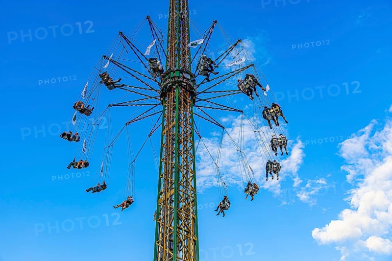 Oktoberfest attraction amusement ride Kettenflieger in front of a white-blue sky, Oktoberfest, Munich, Upper Bavaria, Bavaria, Germany