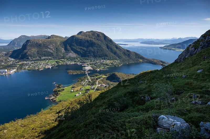 Expansive coastal view with mountains, sea and the village of Midsund, Otroya or Otrøya Island, Møre og Romsdal, Norway