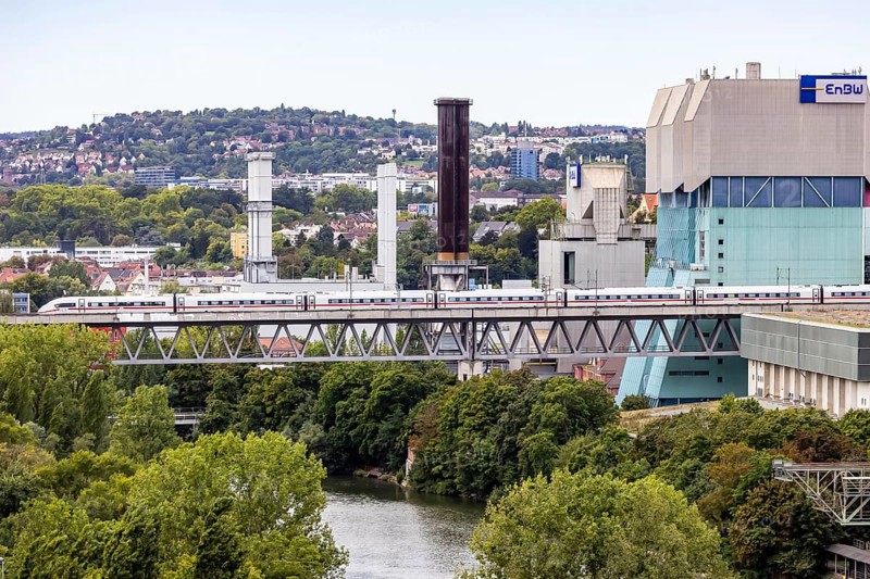 Deutsche Bahn AG ICE en route on the Schuster railway near Stuttgart. Railway viaduct over the Neckar in Stuttgart-Münster with combined heat and power plant of EnBW, Energie Baden-Württemberg. Stuttgart, Baden-Württemberg, Germany