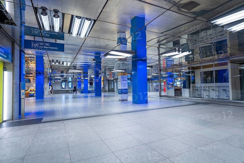 Empty underground building with reflections and blue poles, Münchner Freiheit, Munich, Germany