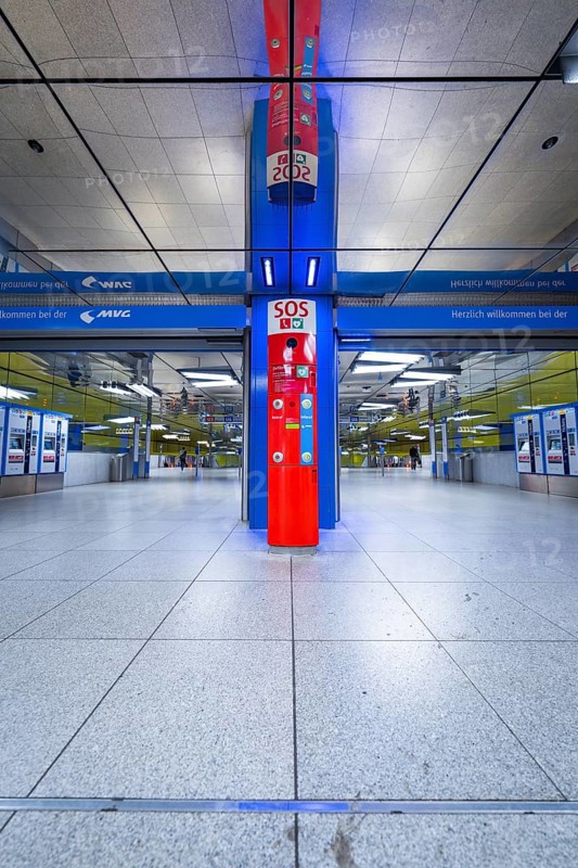 Modern underground station with blue and red elements and SOS station in Munich, Münchner Freiheit, Munich, Germany