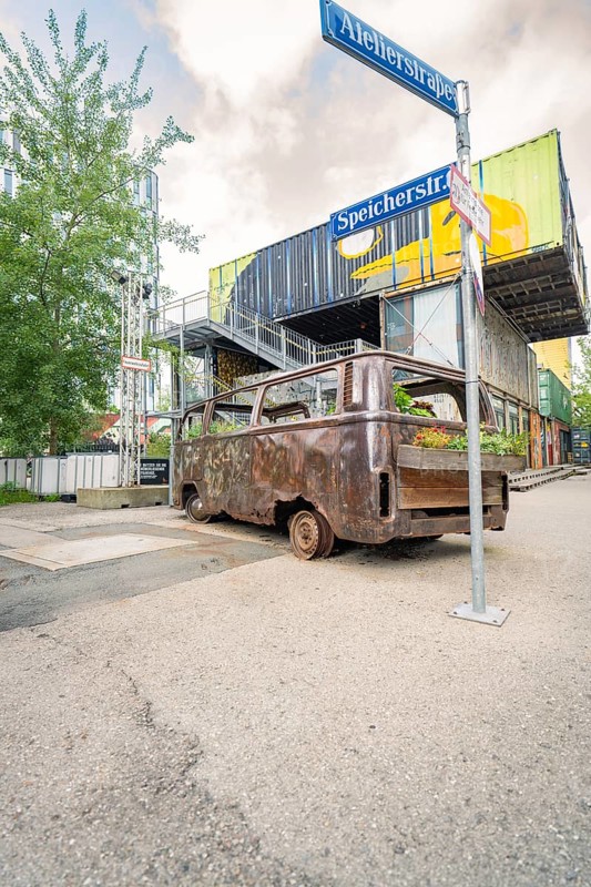 Industrial area with old, planted bus and container buildings in the background, Werksviertel Munich, Munich, Germany