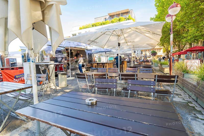 Empty outdoor café with tables and chairs under parasols, sunny and inviting, Sindelfingen, Böblingen district, Germany