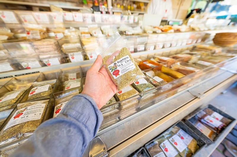 Person holding a rosemary packet in a spice market, Sindelfingen, Böblingen district, Germany