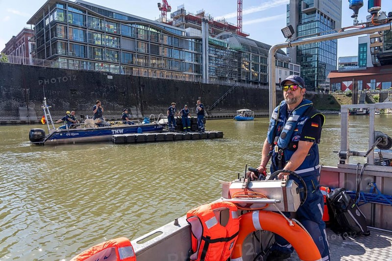 Multi-purpose boat of the THW during a training trip on the Rhine, Medienhafen in Düsseldorf, of the specialist group for water hazards, this type of boat is used to transport people and goods as a rescue boat and as a working platform, during the major exercise FÜLEX25, lasting several days, of the THW, Technisches Hilfswerk, Landesverband North Rhine-Westphalia, on 4 weekends over 3500 volunteers from the 127 North Rhine-Westphalia local associations practise many different deployment scenarios