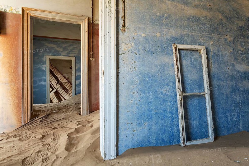 At Kolmanskop, the abandoned ghost town of the diamond days of the early 1900 and of German origin. Inside the restricted Diamond Area east of the coastal town of Lüderitz. Namib Desert, Namibia