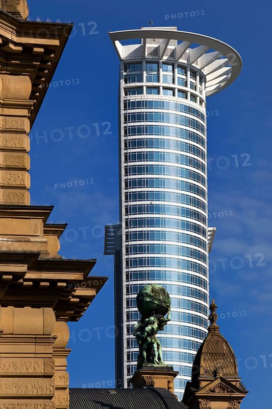 Side front of the main railway station with Atlas carrying the globe on his shoulders in front of the DZ Bank tower block, Frankfurt am Main, Hesse, Germany