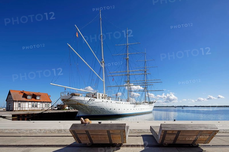 Woman with sun hat on a lounger, Gorch Fock, also Gorch Fock I, built in 1933 by Blohm & Voss for the Reichsmarine, named after the writer Gorch Fock, barque, three-master, sail training ship, today museum ship, An der Fährbrücke, harbour island, old town, Hanseatic city of Stralsund, Mecklenburg-Western Pomerania, Germany