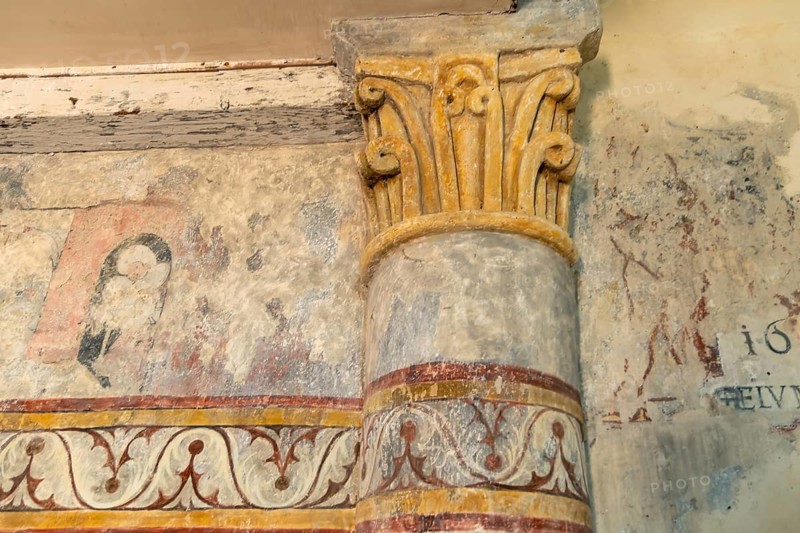 Saint Jean Chapel features ancient wall paintings showcasing religious figures with vibrant colors and intricate details. Champeix village. Puy de Dome. Auvergne Rhone Alpes. France