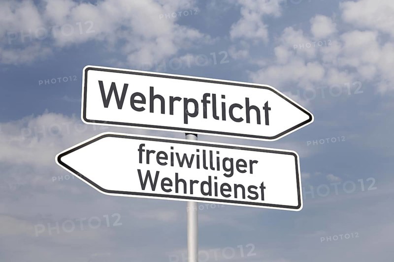(Photomontage) Directional arrows pointing in the directions of MANDATORY DEFENCE and VOLUNTARY DEFENCE SERVICE