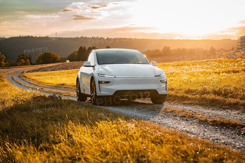 White car on a gravel road through a golden meadow at sunset, Tesla Model Y Juniper, electric car