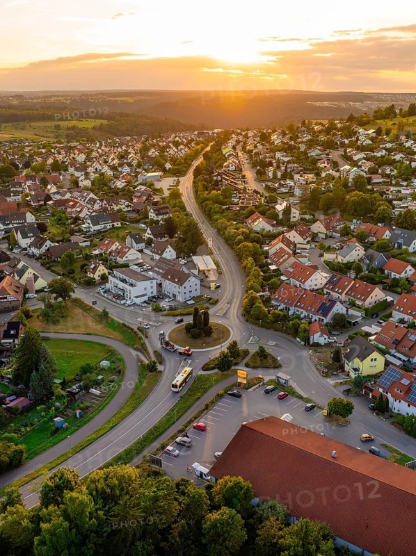 Urban settlement with red roofs and winding streets in the setting sun, small town pearl Calw, Black Forest, Germany