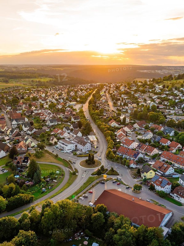 Residential neighbourhood with red roofs and winding streets at a gentle sunset, small town pearl Calw, Black Forest, Germany