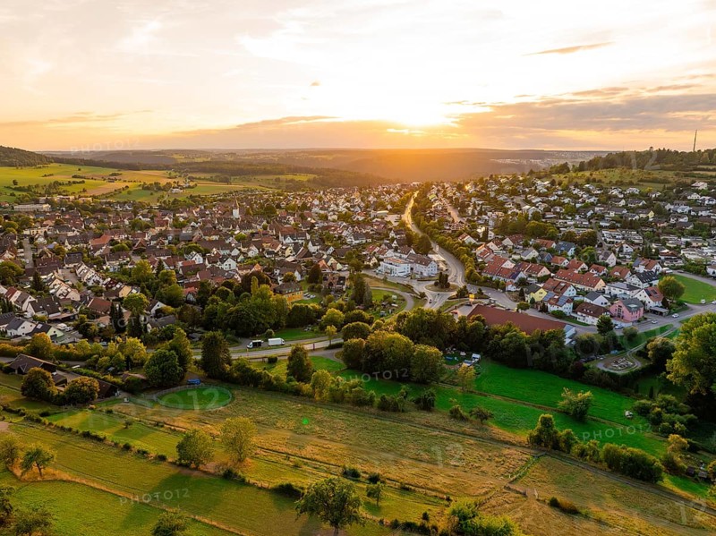 Spacious residential area with open fields and forests at sunset, small town of Perle Calw, Black Forest, Germany