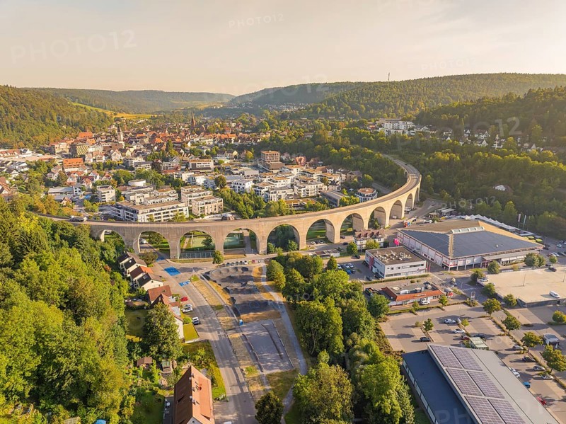 Large viaduct leading over a town and through a hilly landscape, shown from the air, small town of Perle Nagold, Black Forest, Germany