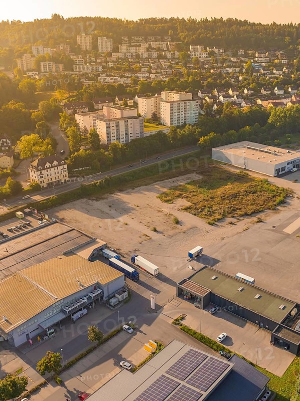 Industrial and residential area at dusk with surrounding nature and urban development, small town of Perle Nagold, Black Forest, Germany