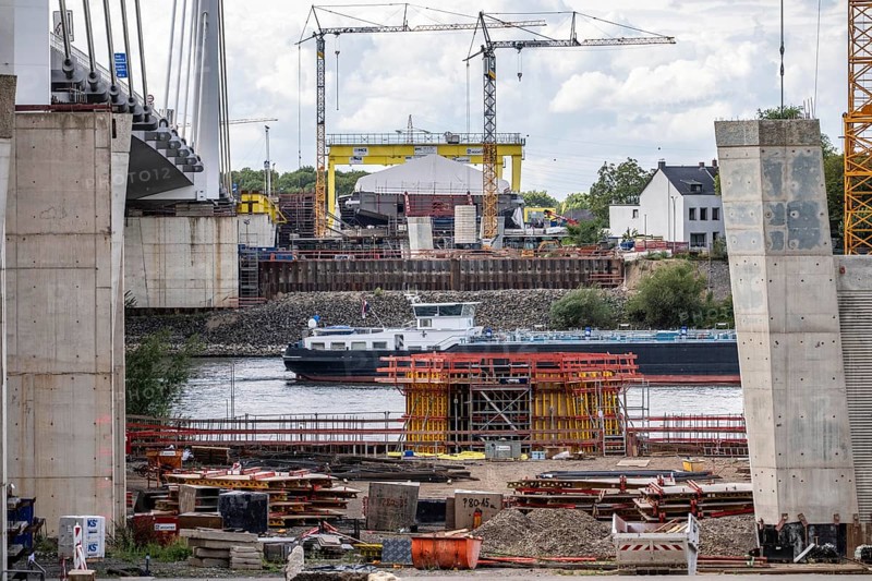 New construction of the second motorway bridge Neuenkamp of the A40, over the Rhine near Duisburg, parallel to the already existing first bridge, most of the new bridge piers are in place, two first bridge segments are finished and have already been moved towards the river on both sides of the Rhine, full completion is planned for 2028, North Rhine-Westphalia, Germany