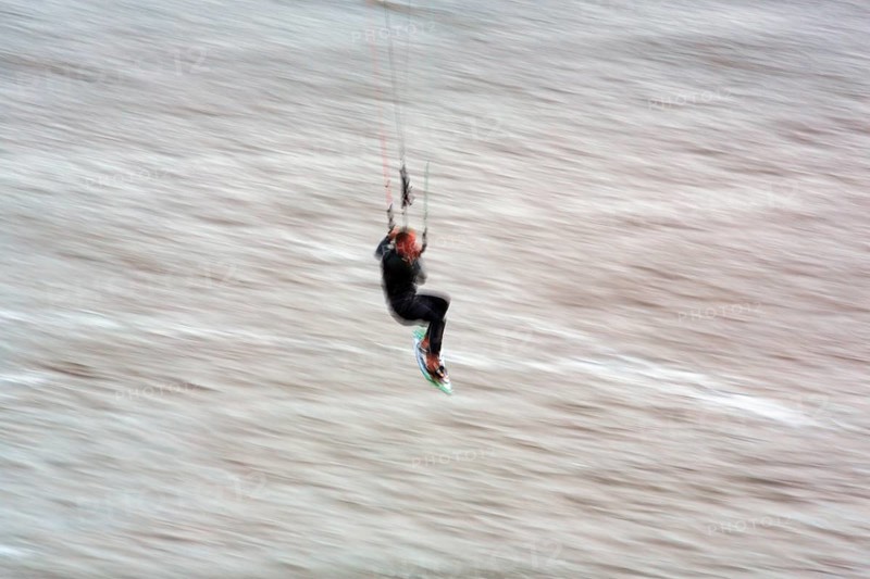 Kitesurfer jumping in the surf, wiping effect, long exposure, Sankt Peter-Ording, Eiderstedt peninsula, Wadden Sea National Park, North Frisia, Schleswig-Holstein, Germany