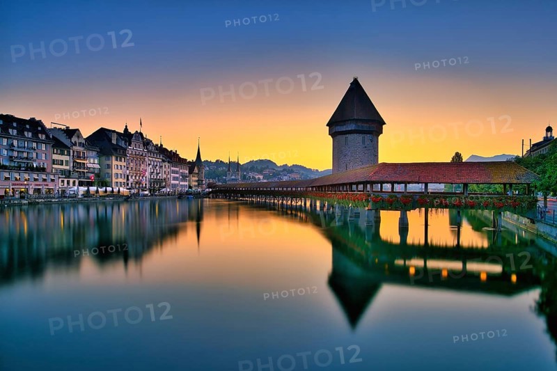 Chapel bridge with water tower reflected in the river Reuss, Lucerne old town at dawn, Canton Lucerne, Switzerland