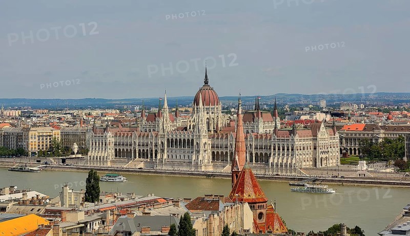 Panoramic view of the hungarian parliament building on the danube river in budapest, hungary, showcasing the city's architectural beauty and historical significance