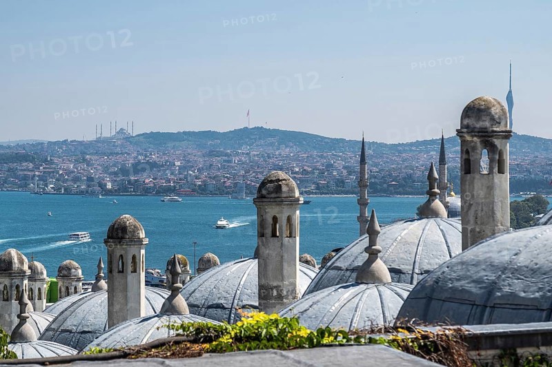 Traditional ottoman architecture dominates the foreground, with the bosphorus strait and the asian side of istanbul stretching out beyond
