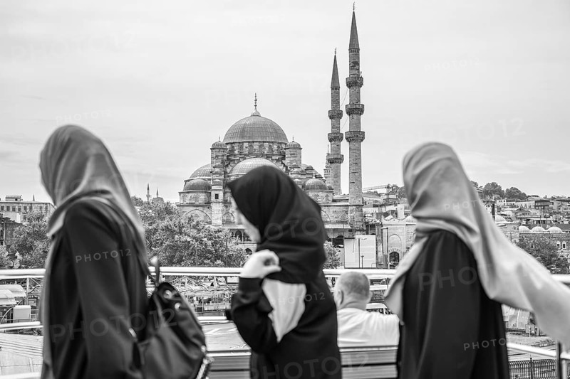 Three muslim women walking through istanbul, admiring the stunning suleymaniye mosque in the background, embracing the city's rich culture