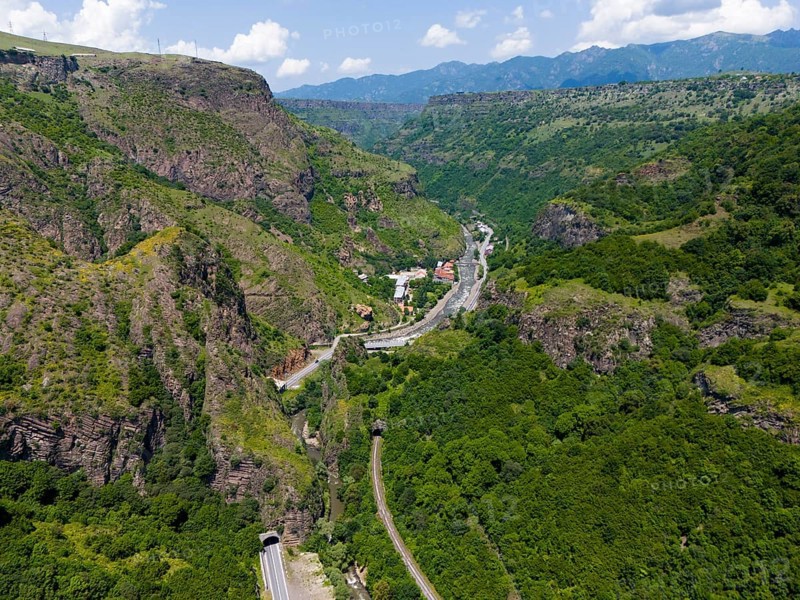 View of valley with roads, tunnels and houses in green mountain landscape, aerial view, landscape near Dzoraget, river Pambak in front of the tunnel, river Debed, gorge Debed, Lorikeet province, Armenia