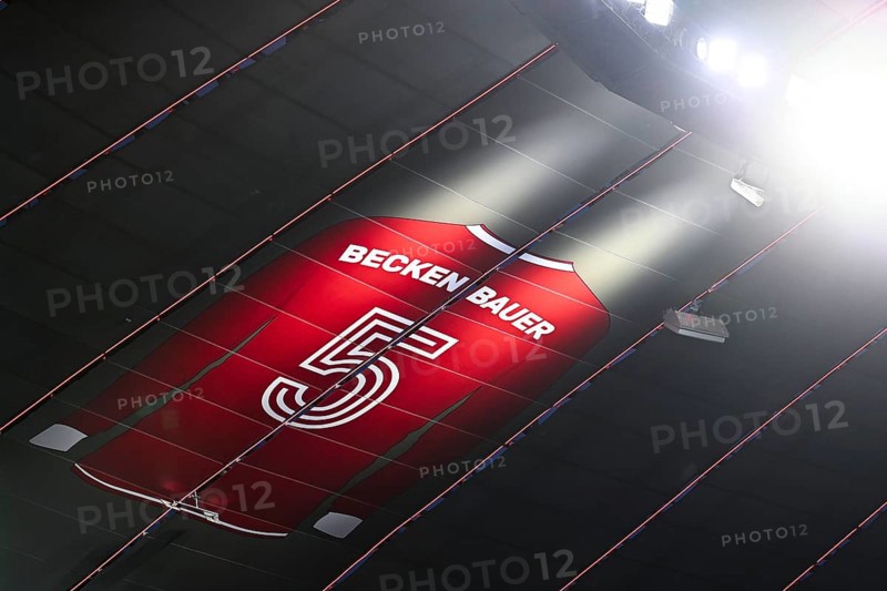 Larger-than-life jersey of Emperor Franz Beckenbauer with shirt number 5 hangs in the grandstand roof of the south curve, 125th anniversary of FC Bayern Munich FCB, radiance, Allianz Arena, Munich, Bavaria, Germany