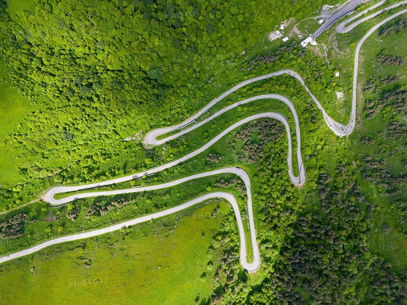 Aerial view of a serpentine road winding through a green, wooded landscape, aerial view, road H52 above a tunnel, Dilijan, Dilijan, Delijan, Delijan, Dilijan National Park, Tavush Province, Tavush, Tavush, Armenia