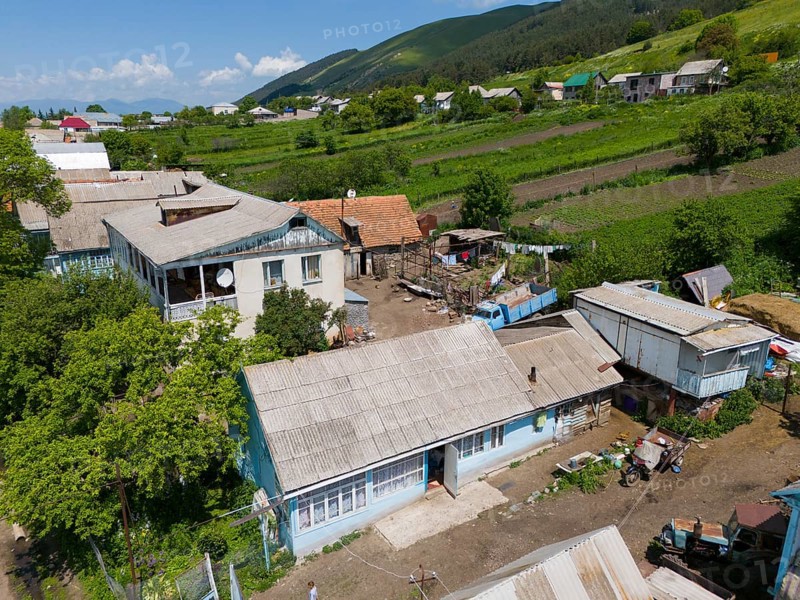 Rural scene with traditional buildings and view of fields and surrounding nature, aerial view, Lermontovo, inhabited by spiritual Christians Pryguny and Molokans from Russia, Lorikeet Province, Armenia