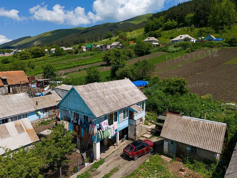 Village with traditional houses, colourful clothes on the washing line, rural idyll with mountains in the background, aerial view, Lermontovo, inhabited by spiritual Christians Pryguny and Molokans from Russia, Lorikeet province, Armenia