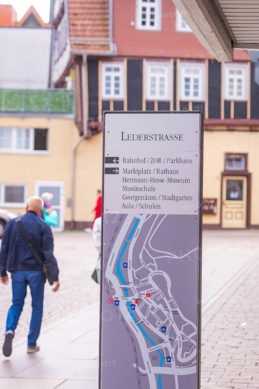 Signpost in a picturesque old town with half-timbered houses in the background, small town pearl Calw, Black Forest, Germany