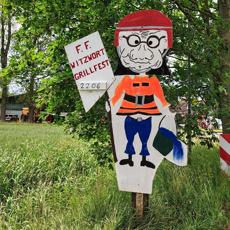 Funny sign with fireman figure and water bucket, inscription, invitation to barbecue, volunteer fire brigade, Witzwort, North Frisia, Schleswig-Holstein, Germany