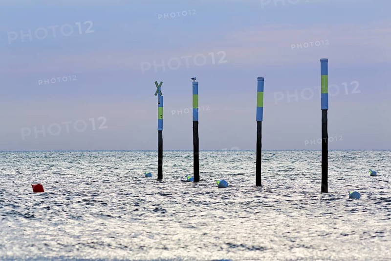 Four poles in a row, marker, sea mark, buoys, evening sky, Sankt Peter-Ording, Eiderstedt peninsula, Wadden Sea National Park, North Sea, North Frisia, Schleswig-Holstein, Germany