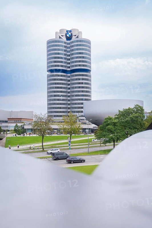 Tall, modern building with striking design and neighbouring green space, BMW Welt, Munich, Germany