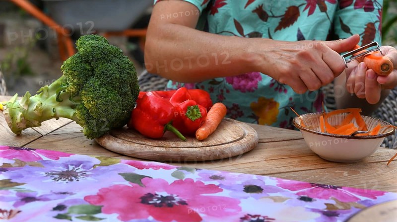 Various vegetables being prepared for a meal, carrots being peeled, Bavaria, Germany