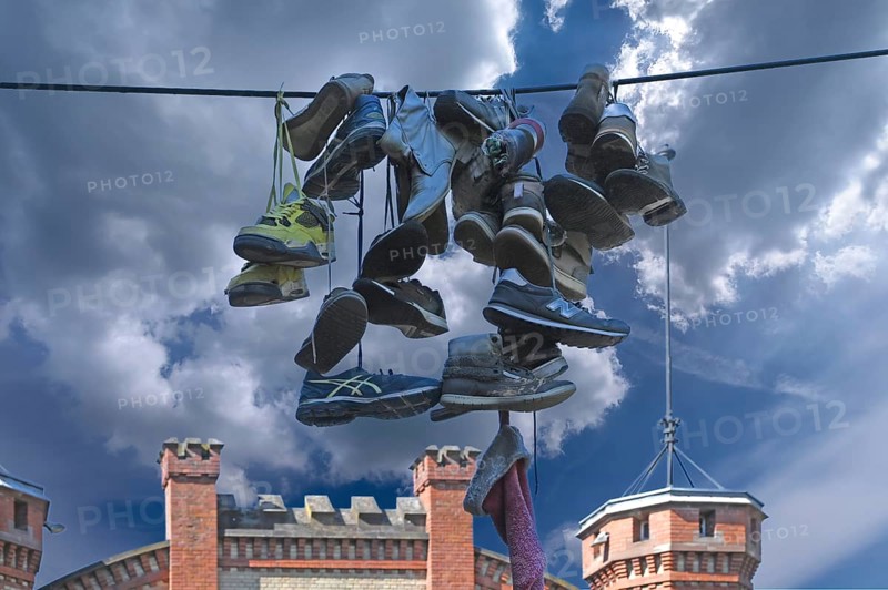 Shoes hanging on a leash in the courtyard of a residential home for addicts, each shoe a reminder of a deceased person, Baden-Württemberg