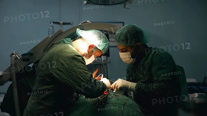 Several doctors performing a complex surgical operation inside an operating room for a displaced patient. Aleppo, Syria. October 18, 2022, Aleppo, Syria
