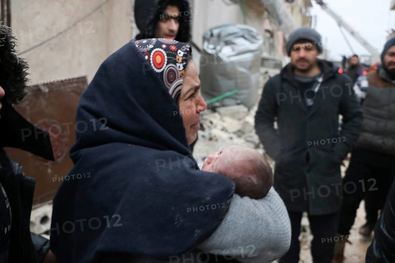 A frightened mother carries her infant after he was pulled from the rubble of a deadly earthquake that struck Turkey and Syria, leaving tens of thousands dead. Aleppo, Syria – Feb 6, 2023, aleppo, syria