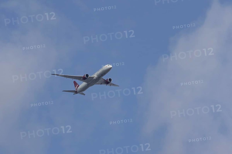 Boeing 787 Dreamliner jet passenger aircraft of Virgin Atlantic airlines in flight in a blue sky, England, United Kingdom