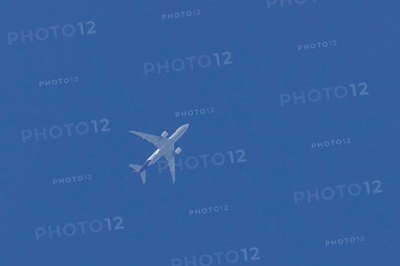 Airbus A300-600RF jet aircraft of FedEx Express airlines in flight in a blue sky, England, United Kingdom