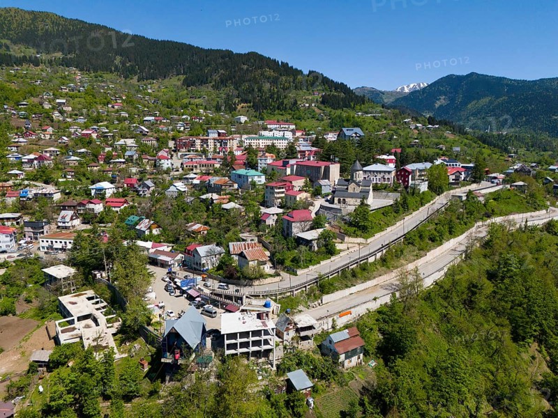 Cityscape embedded in mountains, with colourful houses and lush green surroundings, aerial view, Khulo, Chulo, Autonomous Republic of Adjara, Adjara, Lesser Caucasus, Georgia