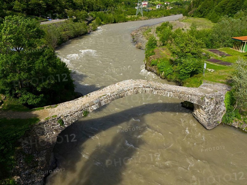 Aerial view of an old stone bridge spanning a river surrounded by green nature, aerial view, stone arch bridge Dandalo, Adjaristskali River, Autonomous Republic of Adjara, Adjara, Adjara, Lesser Caucasus, Georgia