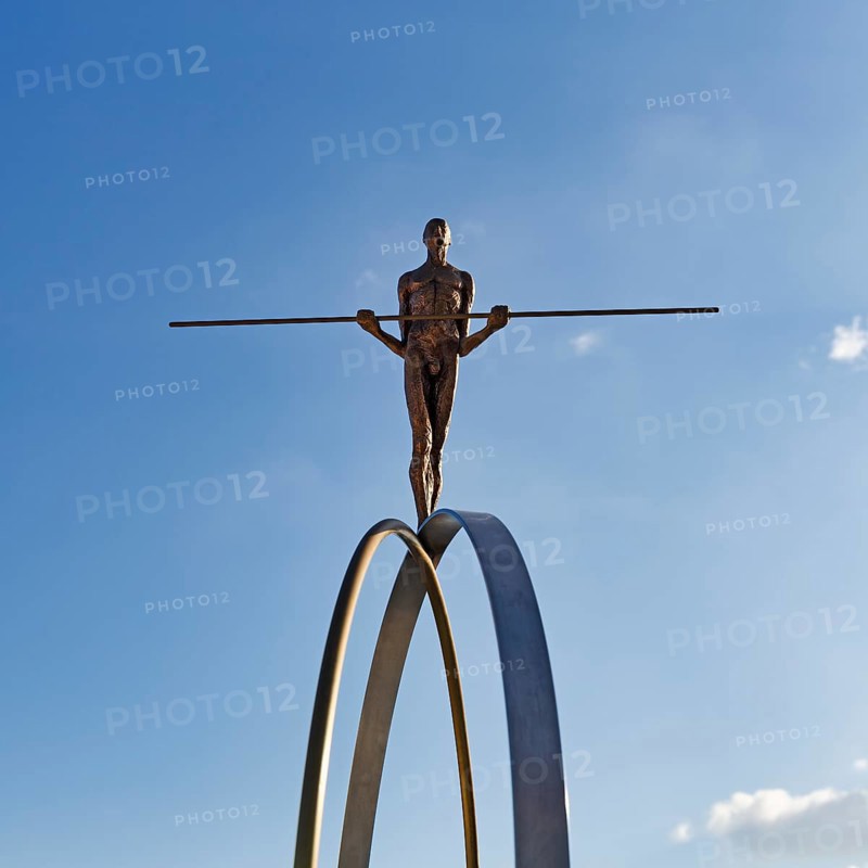 Sculpture Balance by the artist Martina Ondáková in front of a blue sky, human figure balanced, symbolic image, striving for balance and harmony, Oia, Thira, Santorini, Cyclades, Greece