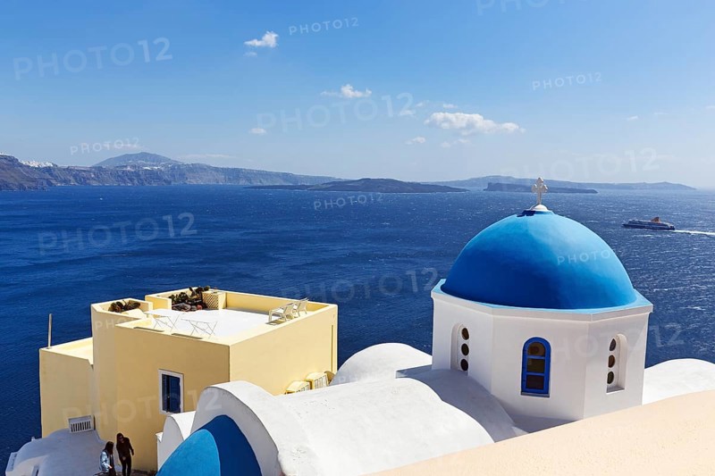 Blue dome of an orthodox church, ferry crossing the sea, Caldera, Oia, Thira, Santorini, Cyclades, Greece