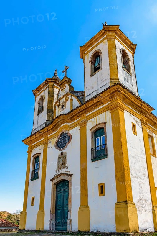 Facade of a baroque church with its towers and crucifix in Ouro Preto, Minas Gerais, Ouro Preto, Minas Gerais, Brazil