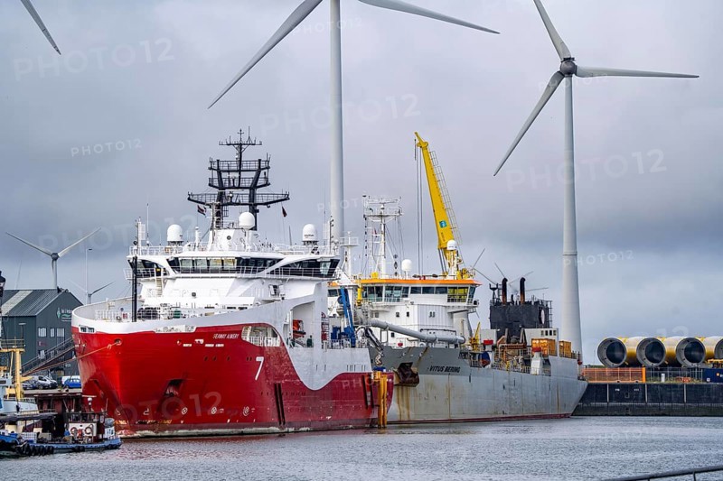 Working vessels in the seaport of Eemshaven, dredger Vitus Bering, aft, cable layer and offshore supply and working vessel Seaway Aimery, Netherlands
