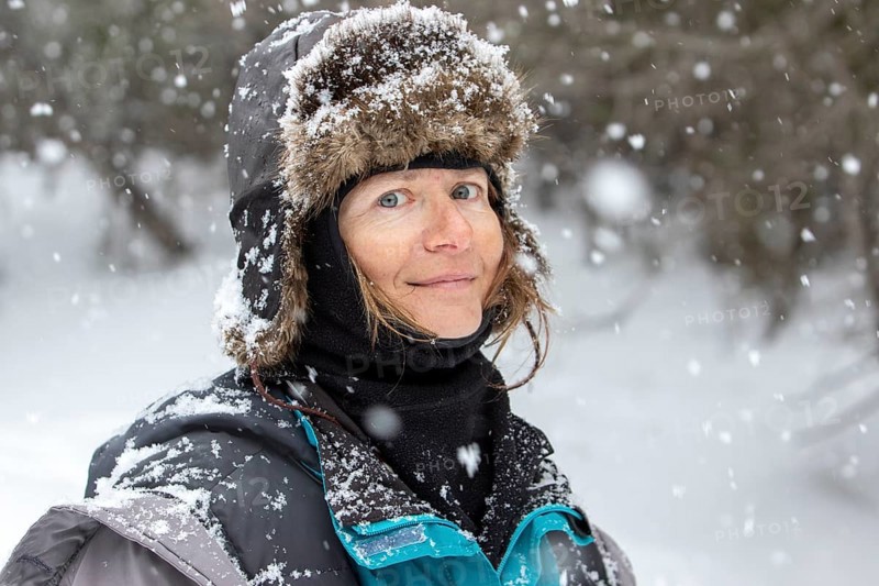 Woman enjoying a cold weather, Woman smiling under a snowfall, Gaspesie national park, Province of Quebec, Canada, north America