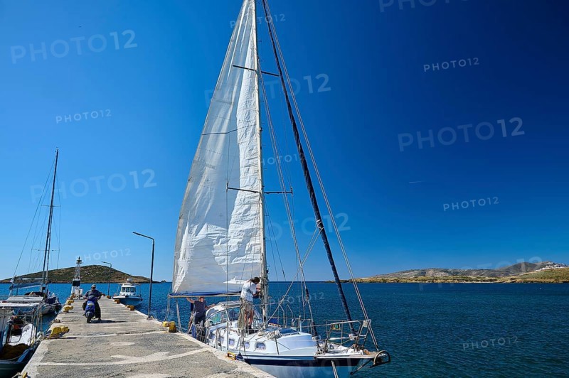 A sailing boat moors in sunny weather at a pier in the deep blue sea, Analipsi, Maltezana, Astypalea, Astipalea, Astipaleia, Dodecanese, Greek Islands, Greece