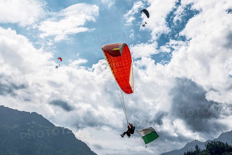 Paragliding tandem flight canton Vaud flag, Interlaken, Switzerland
